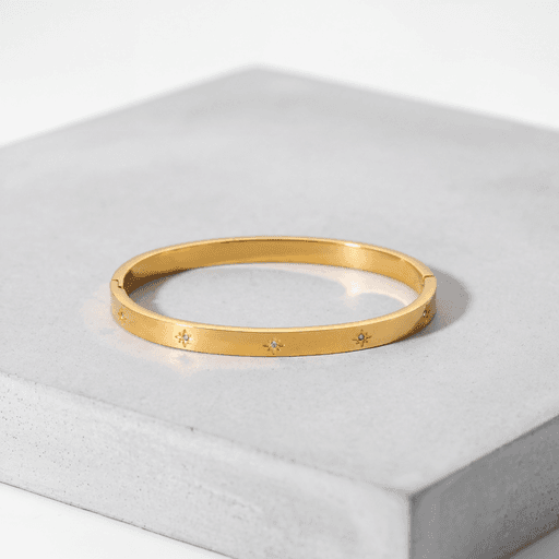 Better Off inaugural bracelet — gold-tone bangle with crystal star details